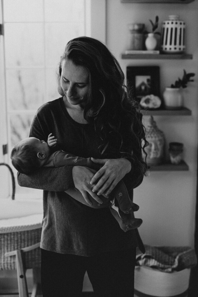 mother holding baby showing real life postpartum healing and postpartum recovery