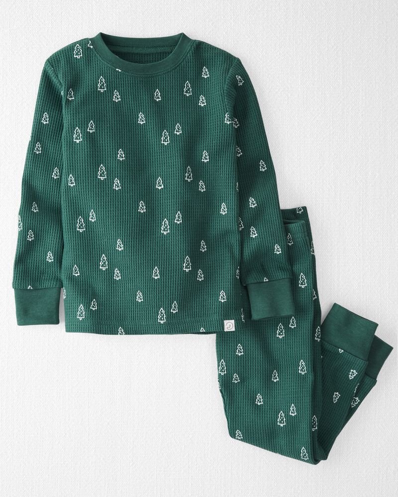 Matching kids holiday pajamas in festive white and green prints