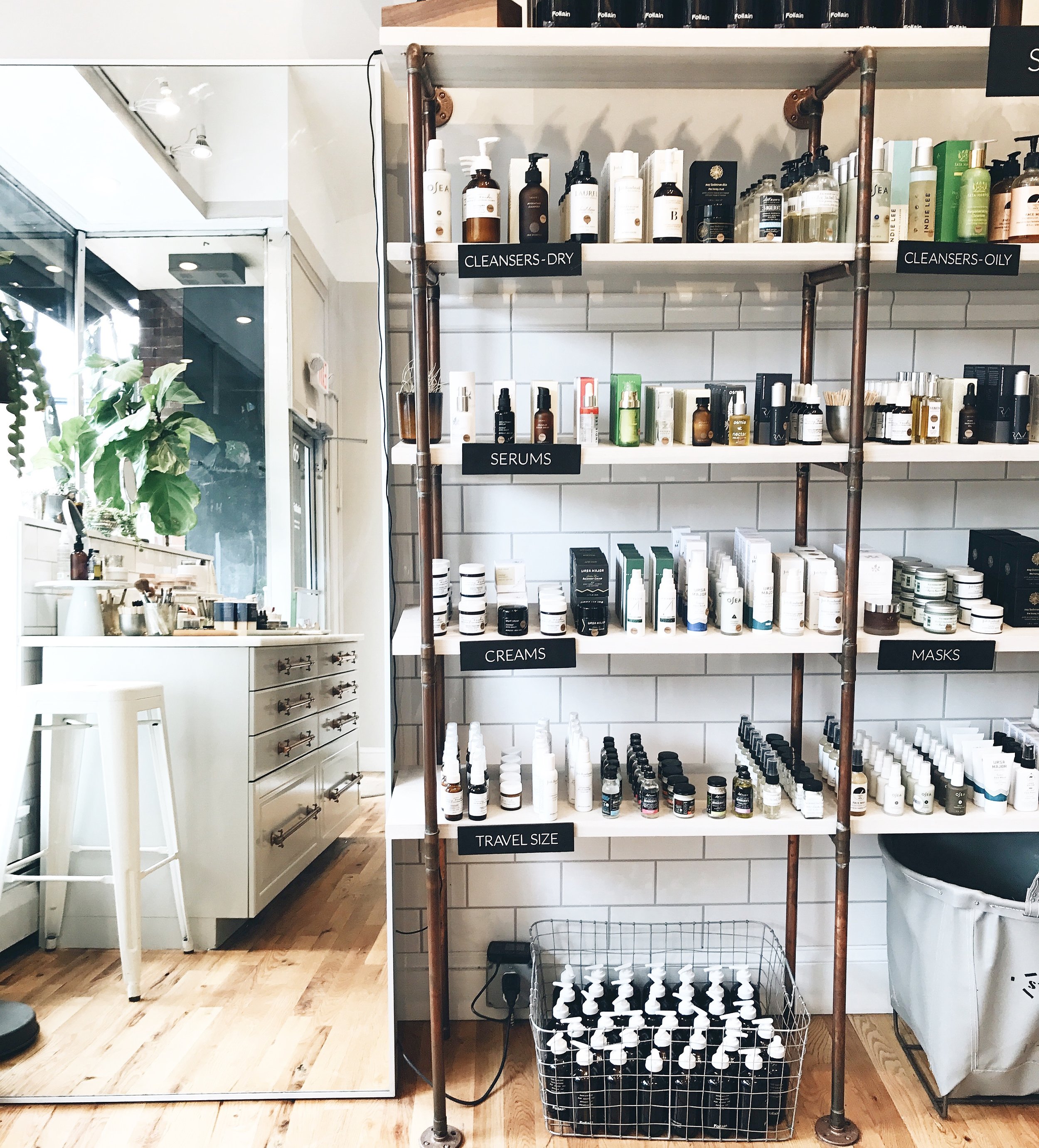 clean beauty store with hundreds of clean beauty skincare products on a wall shelf