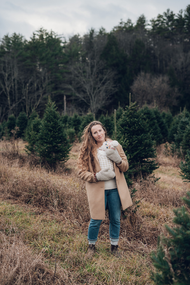 winter capsule wardrobe mom wearing camel coat and jeans