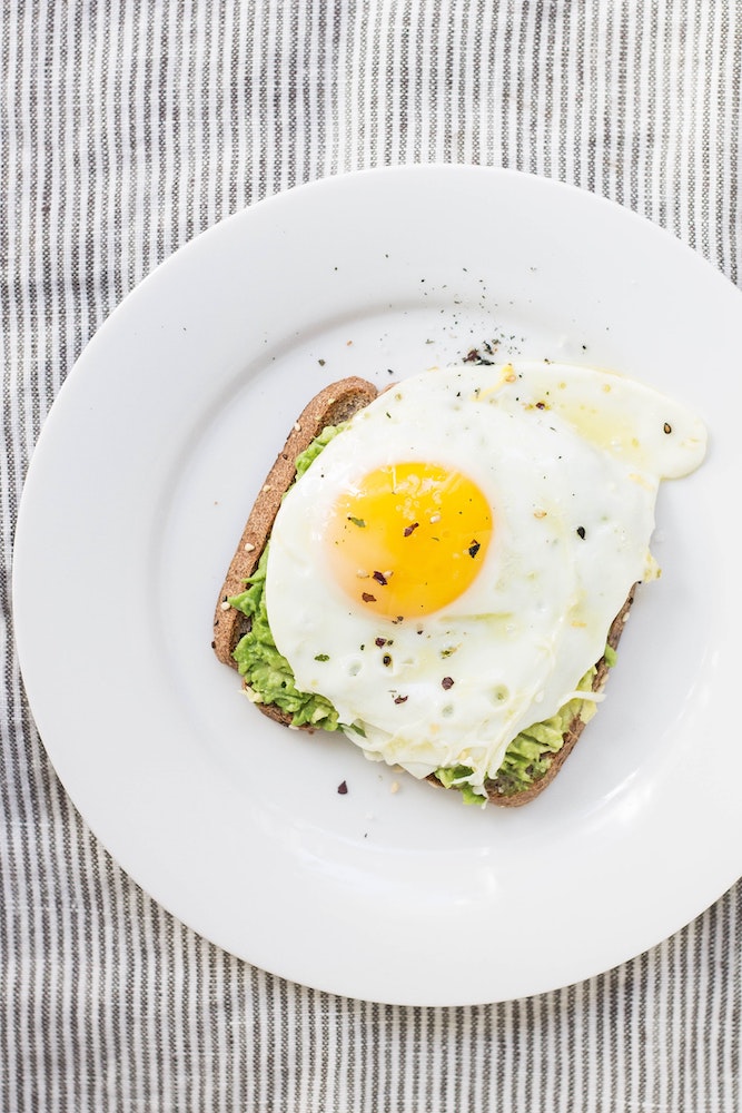 sunny side up egg on avocado toast postpartum healing foods